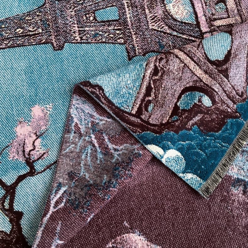 Macro of the woven tower ironwork and blossom against the blue ground with the plum reverse folded back