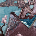 Macro of the woven tower ironwork and blossom against the blue ground with the plum reverse folded back