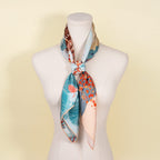 The two lakes silk scarf tied at the neck of a display form