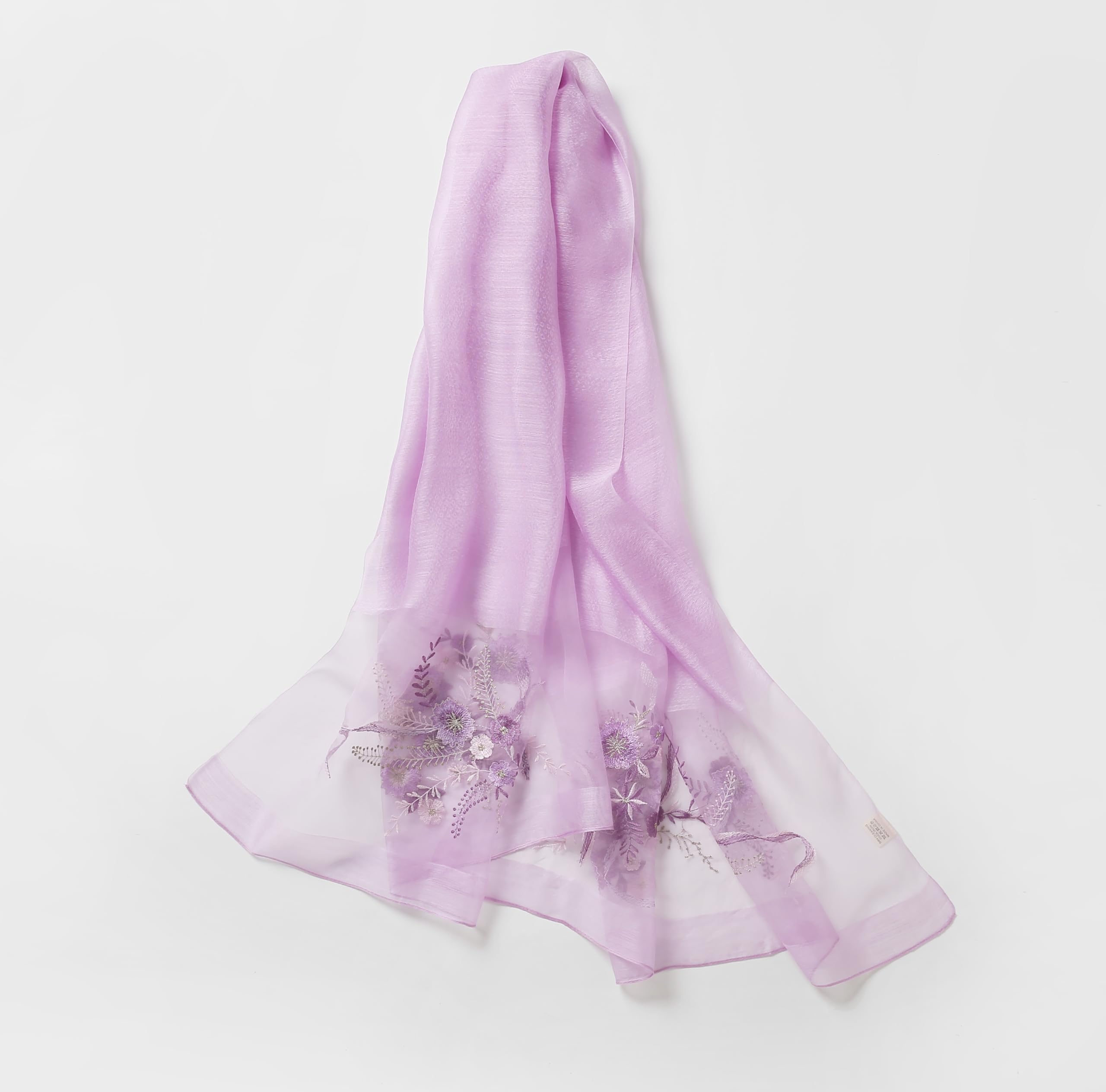 Lavender shawl draped showing purple floral embroidery on the sheer end panel