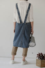 Back of the denim pinafore apron showing the shoulder straps crossed and sewn in place
