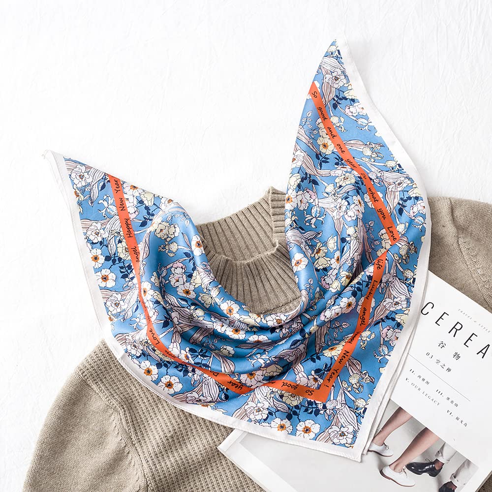 Blue silk square printed with cream blooms and a burnt orange band, draped over a beige knit