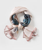 The ink lotus silk scarf rolled and tied into a ring