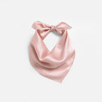 Blush pink silk square folded to a triangle, knot tied at the top of the loop