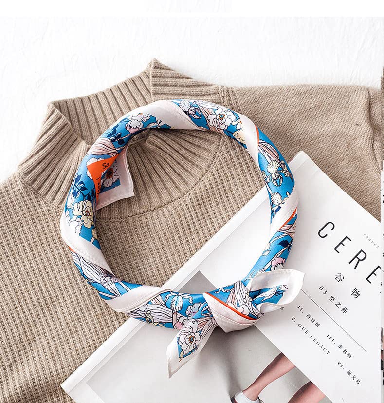 The same blue floral square rolled into a loose collar loop and knotted on a beige ribbed knit