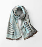 Pale blue horse print shawl looped once at the neck with both fringed ends hanging