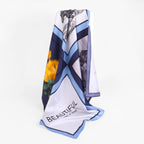The nocturne silk scarf gathered to show the navy sky blue and white bands