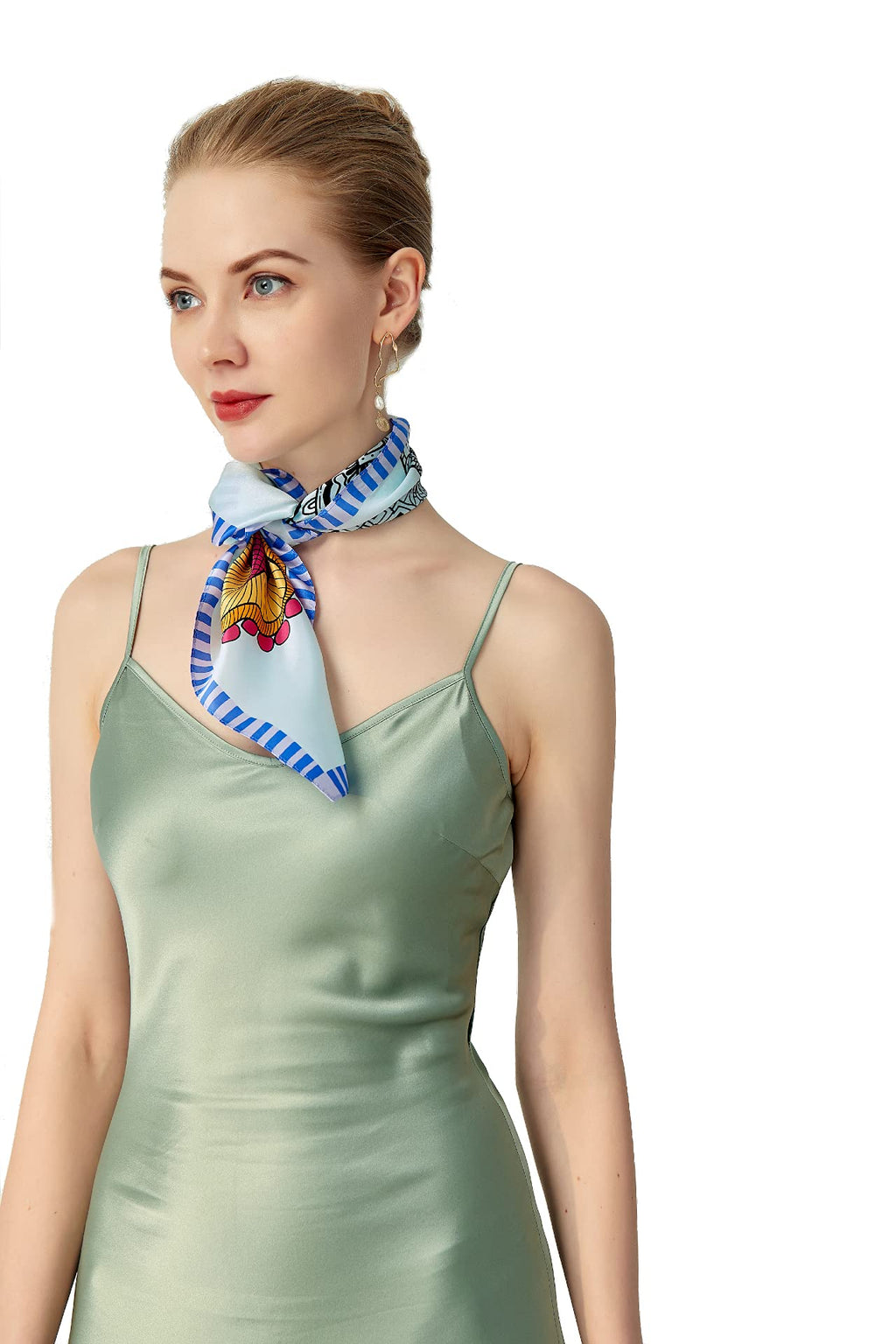 Model in a sage slip dress with the pale blue flower square knotted at her throat