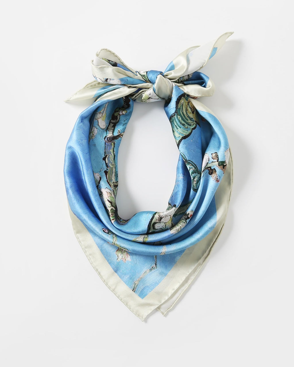 Almond blossom silk scarf rolled and tied into a ring showing the pale cream border