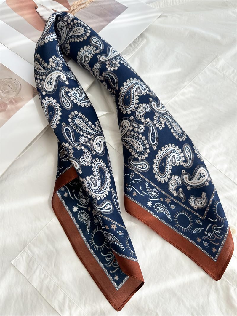 Navy paisley square twisted into a band on white linen, rust-tipped corner showing