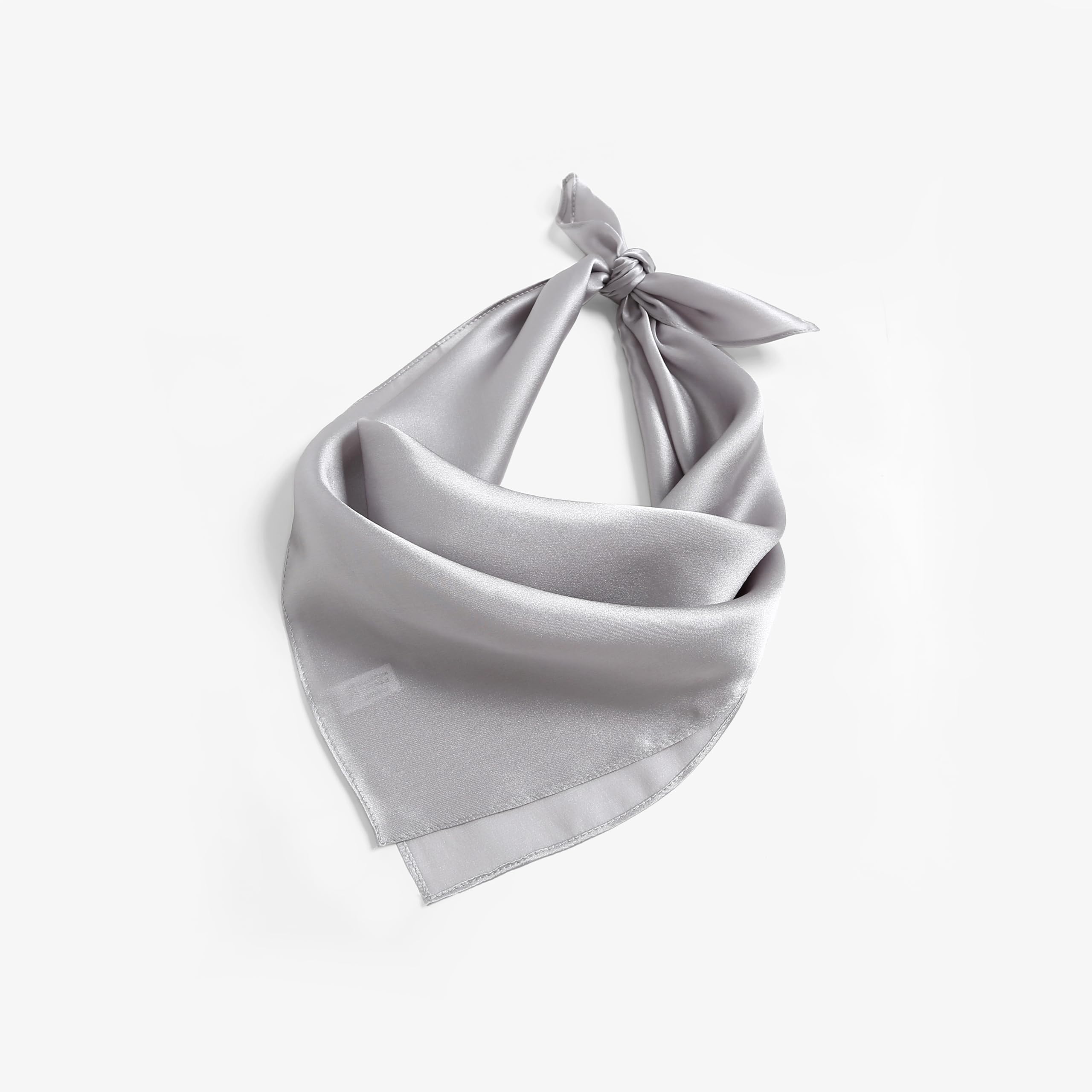 Cloud grey silk square folded to a triangle and knotted like a bandana, woven label showing