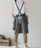 Back view showing the two long denim straps crossed behind the shoulders