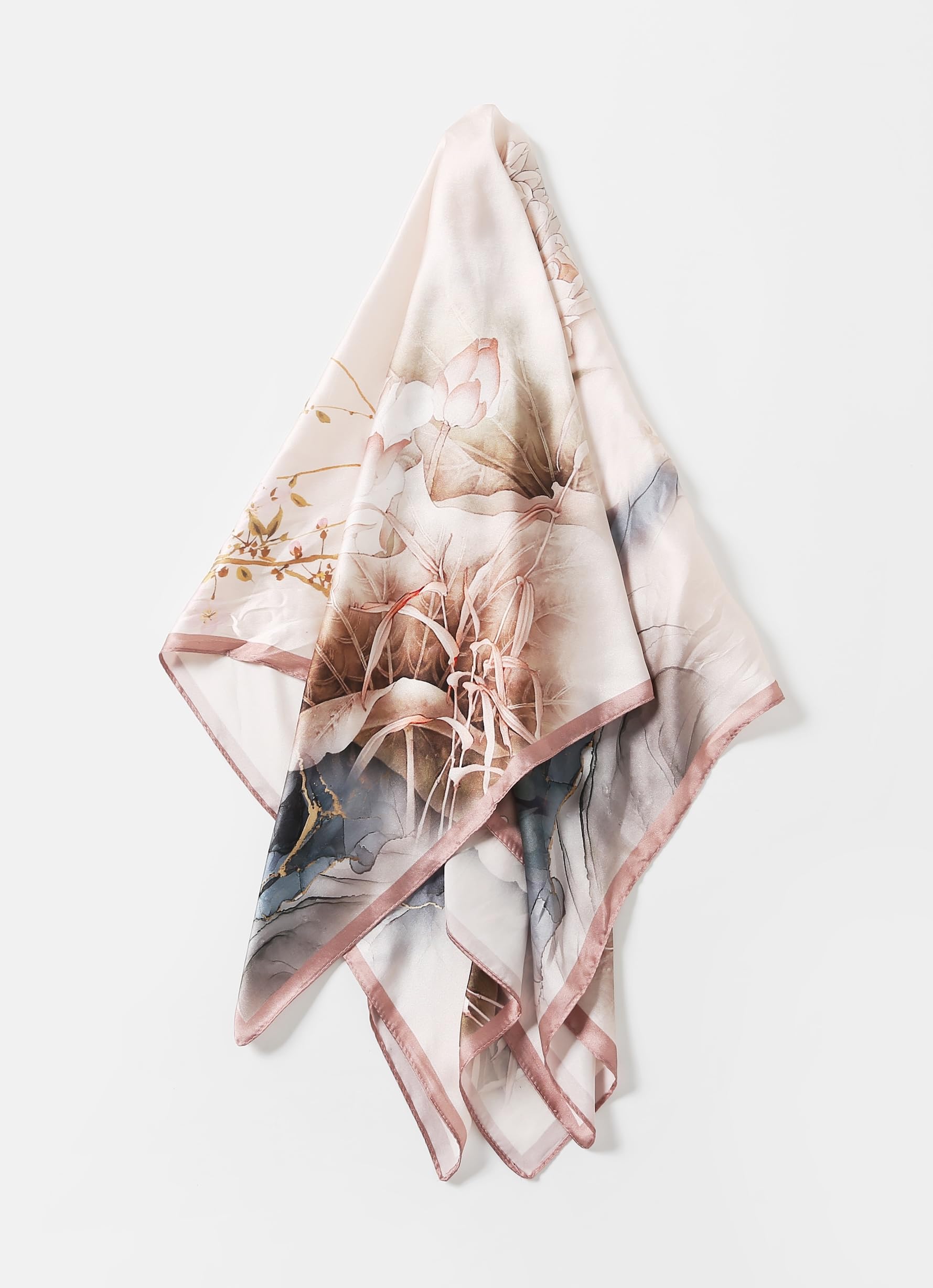 The ink lotus silk scarf folded into a triangle showing the dusty rose border