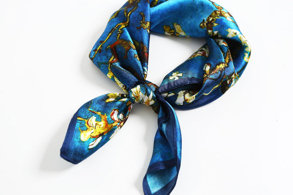 Blue blossom square looped and knotted with the two tails hanging on white