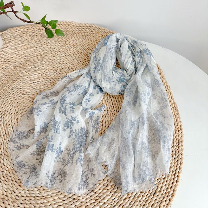 Blue botanical linen scarf draped to show its length and light weight