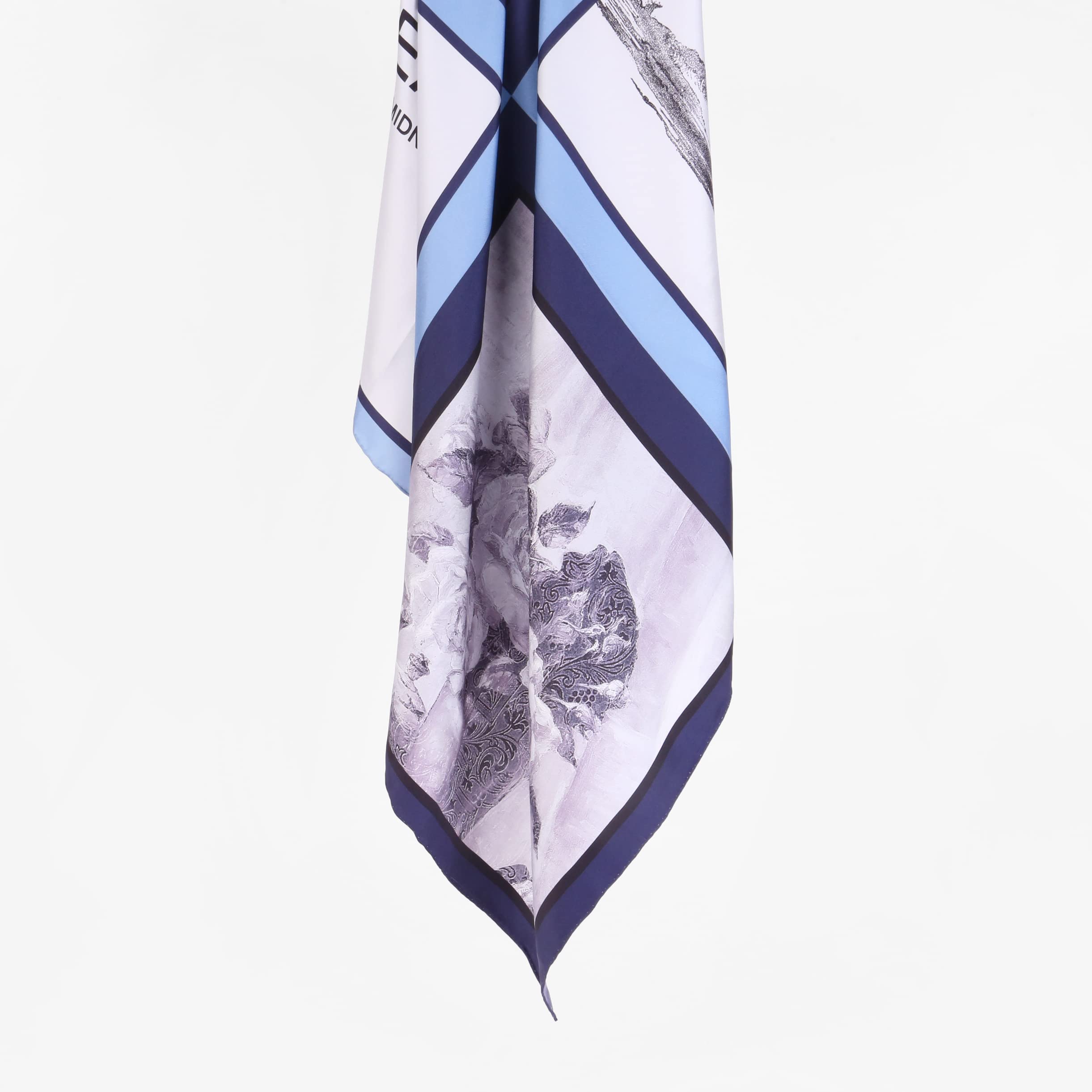 The nocturne silk scarf folded into a long band showing the diagonal navy stripes
