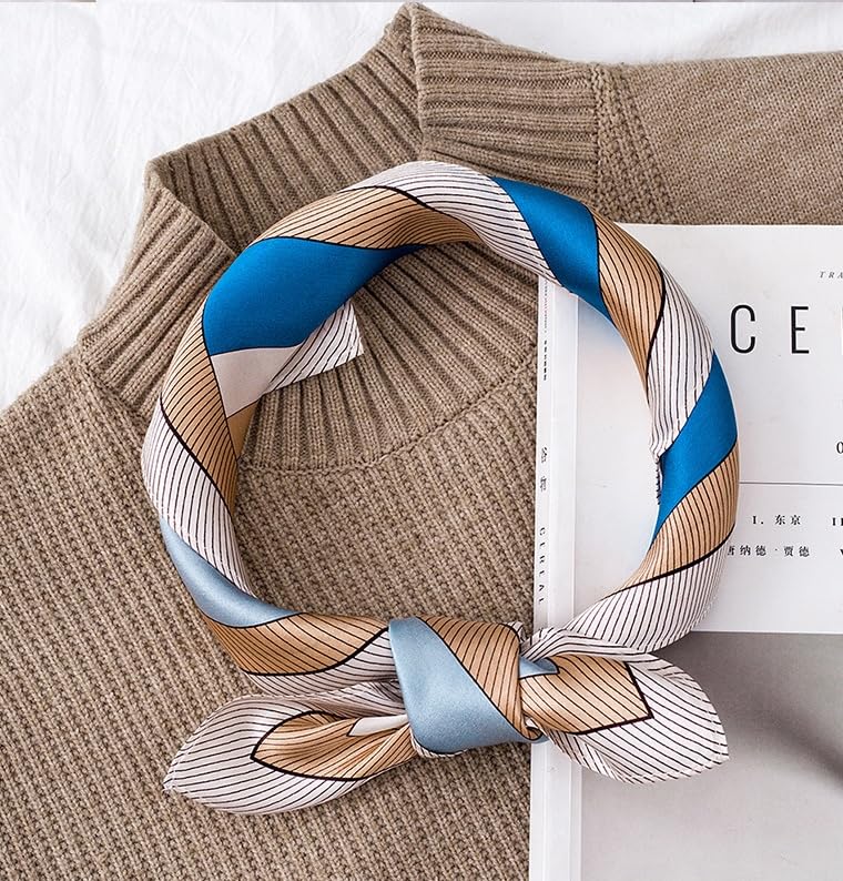 Cat print square rolled into a loop on a camel sweater, fine striped border on show