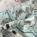 Close-up of aqua charmeuse folds, engraved stirrups and tasselled harness in fine line