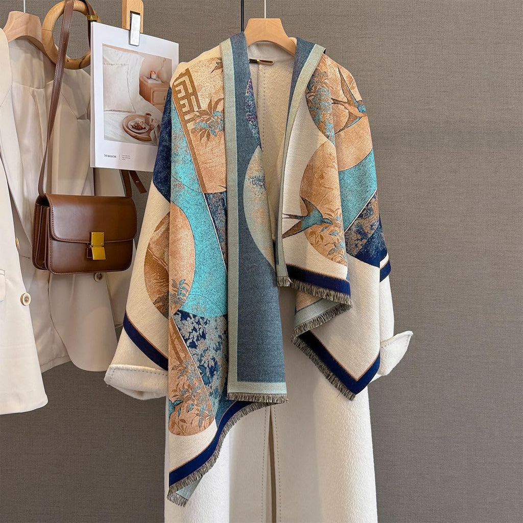The shawl hung open on a rail beside a cream coat and a tan leather bag showing the fan and swallow panels