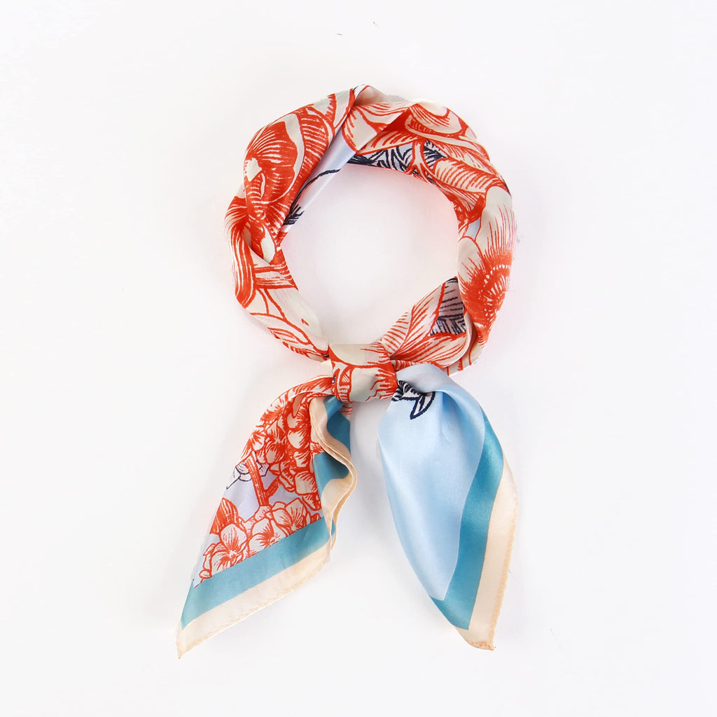 Coral bloom square coiled into a ring and knotted, sky blue border on the tails