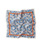 The full square flat, white and pink flowers on mid blue inside a bright orange frame