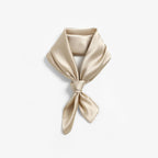 Champagne beige silk folded to a collar and knotted, two pointed tails hanging down