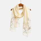 Khaki gold shawl on a hanger showing trailing vine embroidery on both ends