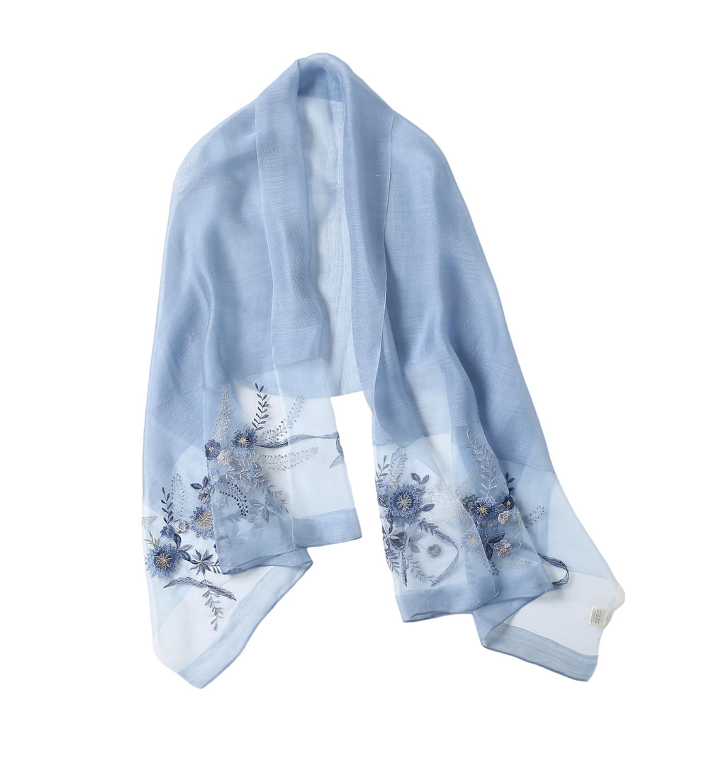 Denim blue semi sheer shawl with blue floral and trailing wisteria embroidery along both ends