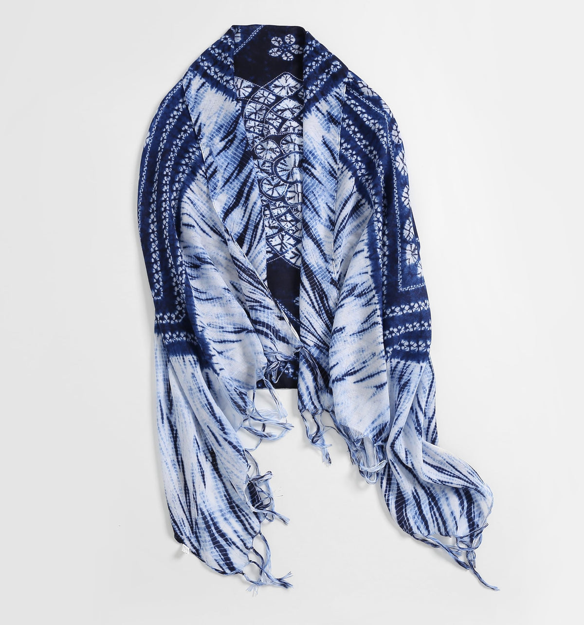 Jeelow indigo batik scarf spread flat, white shibori feather rays framed by navy bordered bands with a patterned centre panel and long fringe