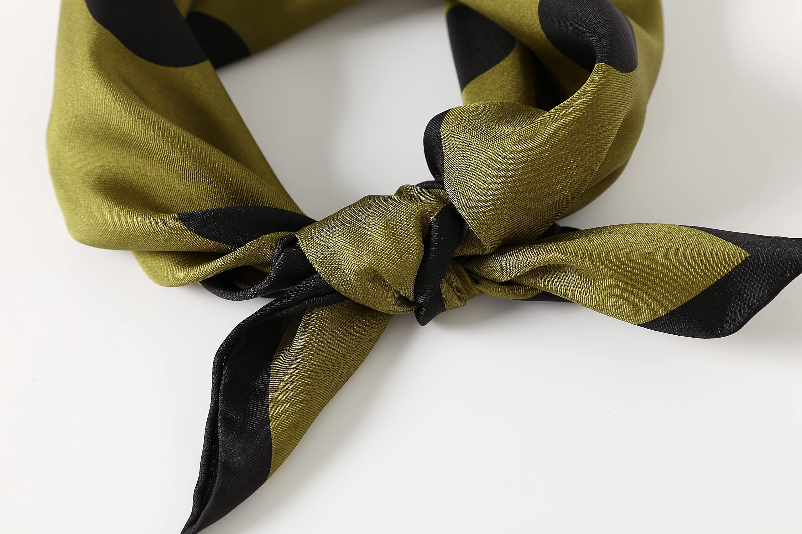 Close-up of the knot: olive silk twill sheen and the black border running along the tails