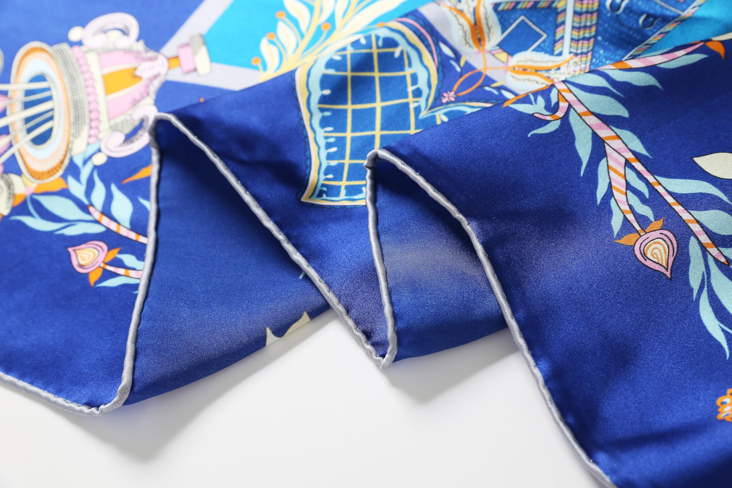 Close up of the cobalt ground and pale folk motifs on silk