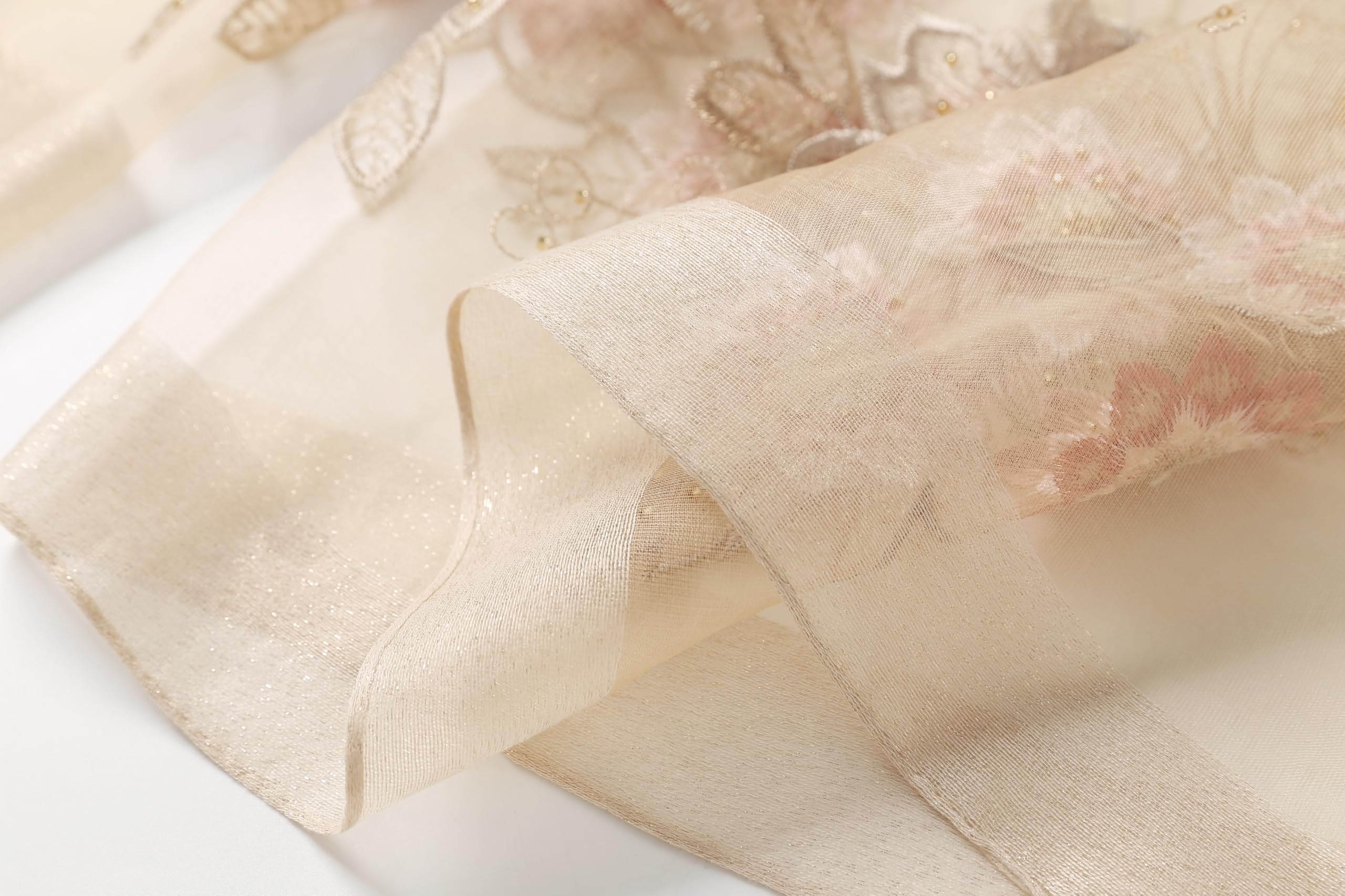 Sheer champagne border folded back against the embroidered panel