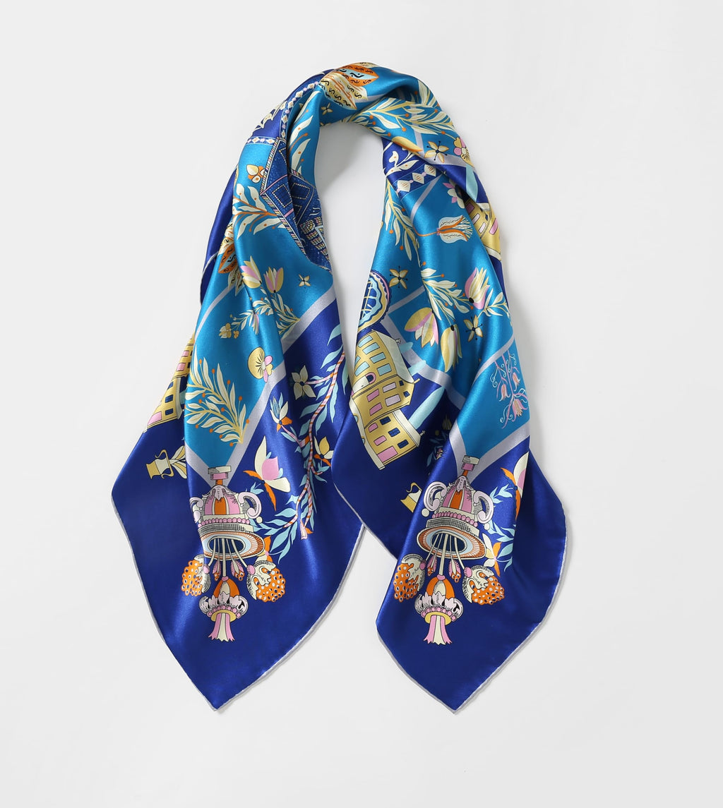 The folk heart silk scarf gathered into loops showing the deep cobalt border