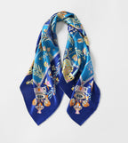 The folk heart silk scarf gathered into loops showing the deep cobalt border