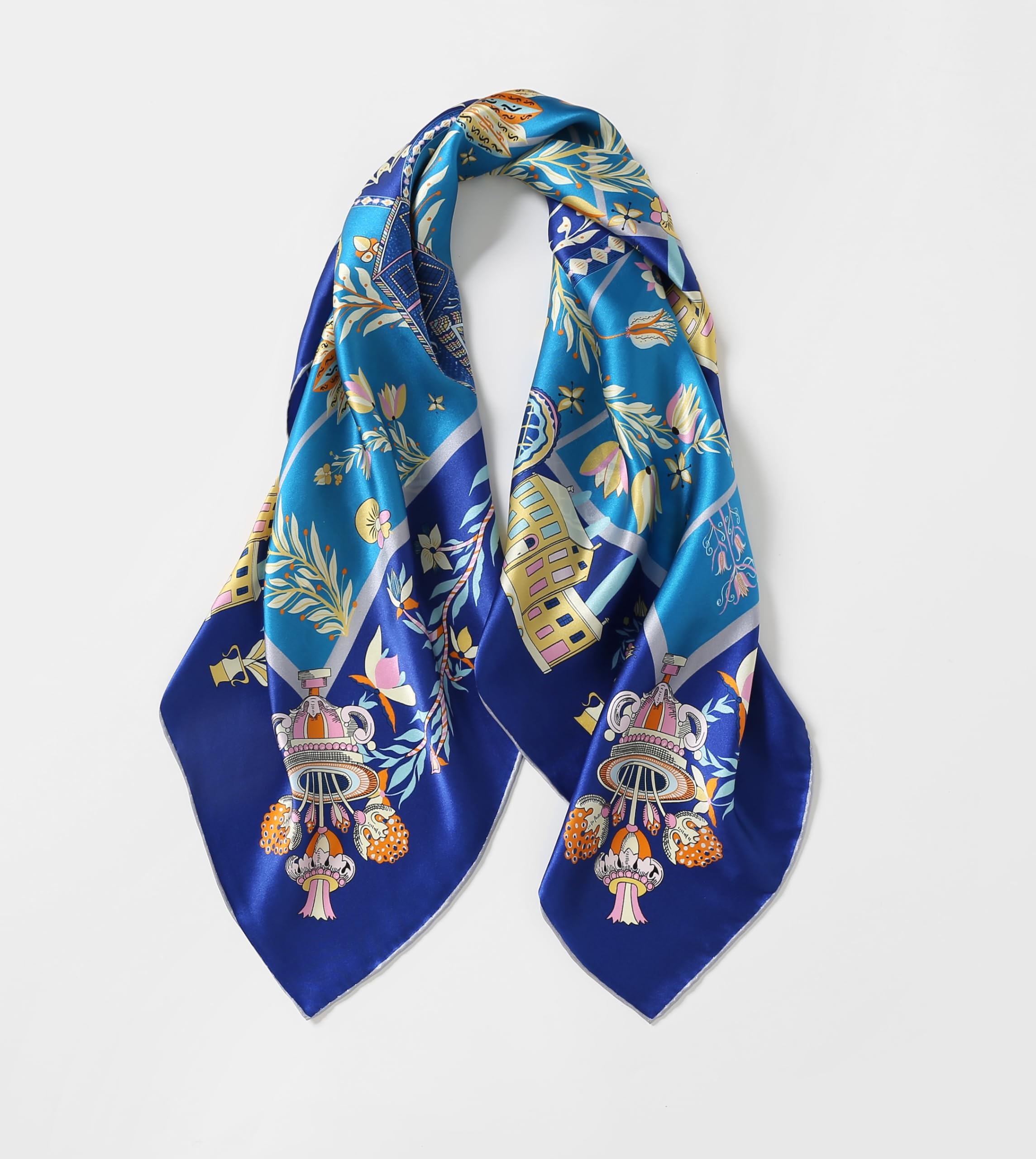 The folk heart silk scarf gathered into loops showing the deep cobalt border