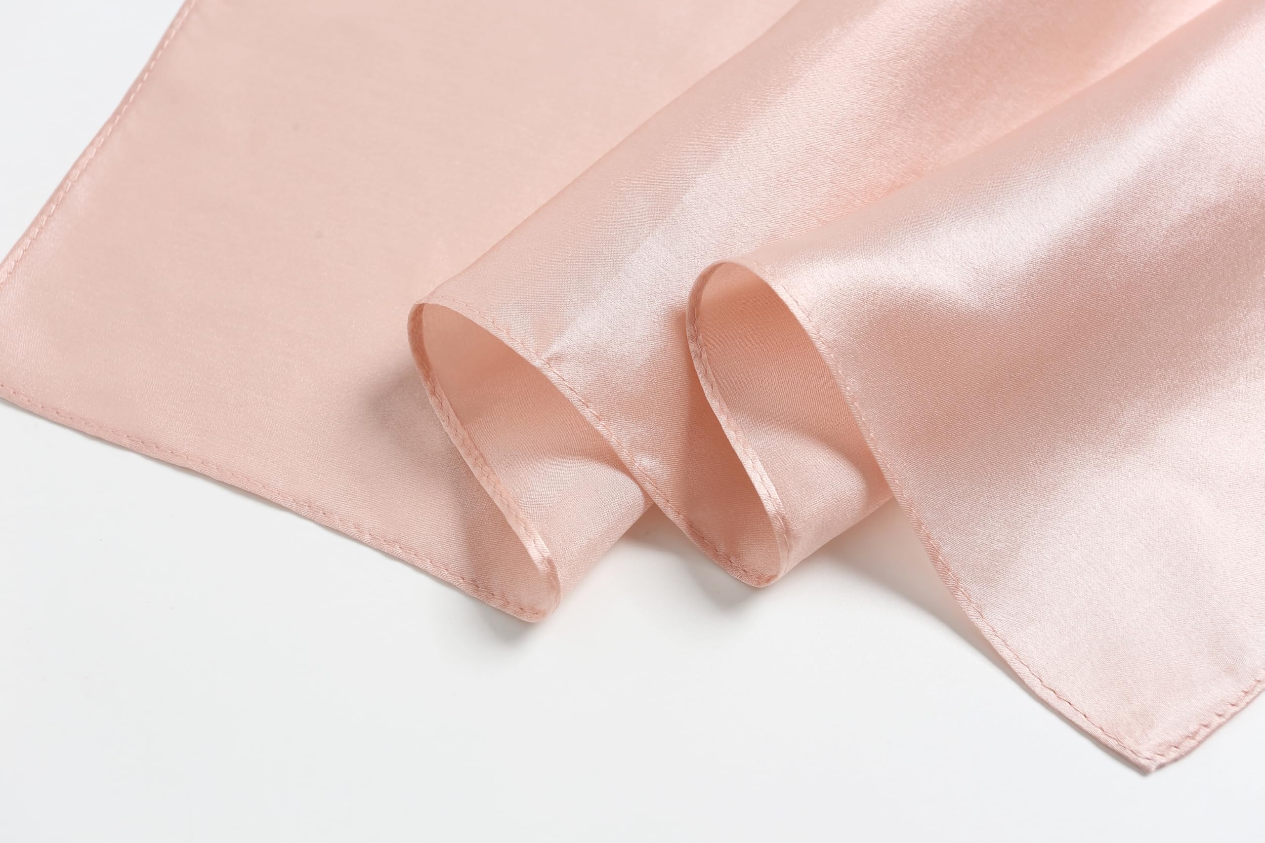 Blush pink silk rolled back in two soft curls, narrow hem and matte reverse showing