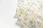 Yellow botanical linen scarf open across the shoulders