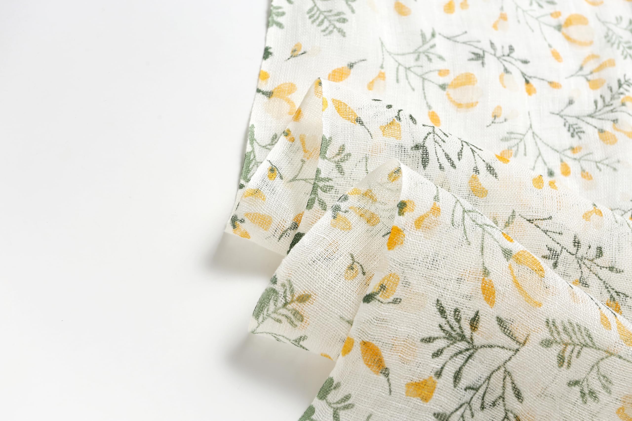 Yellow botanical linen scarf open across the shoulders