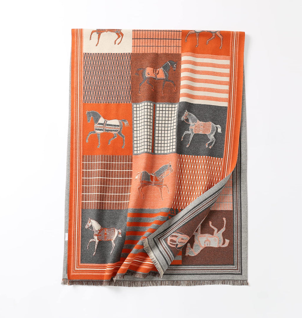 The same shawl laid flat full length with one corner turned back to show the grey striped reverse