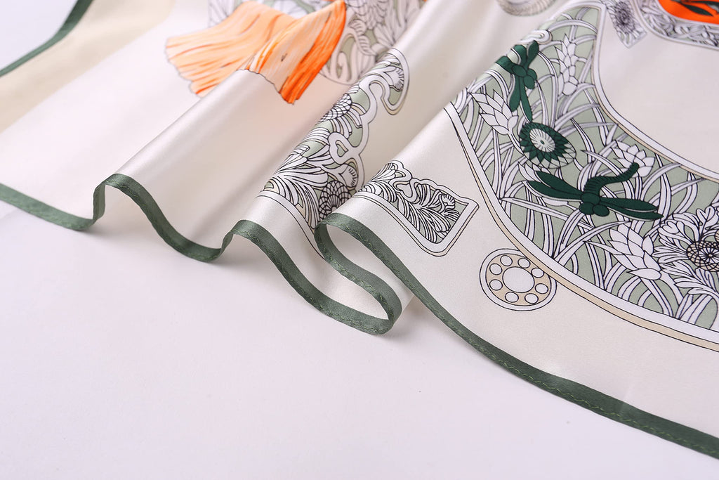 Close up of the deep green border and grey scrollwork on ivory silk