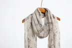 Ink floral linen scarf worn at the neck