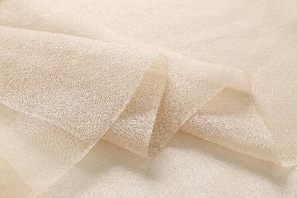 Close up of the sheer champagne fabric folds