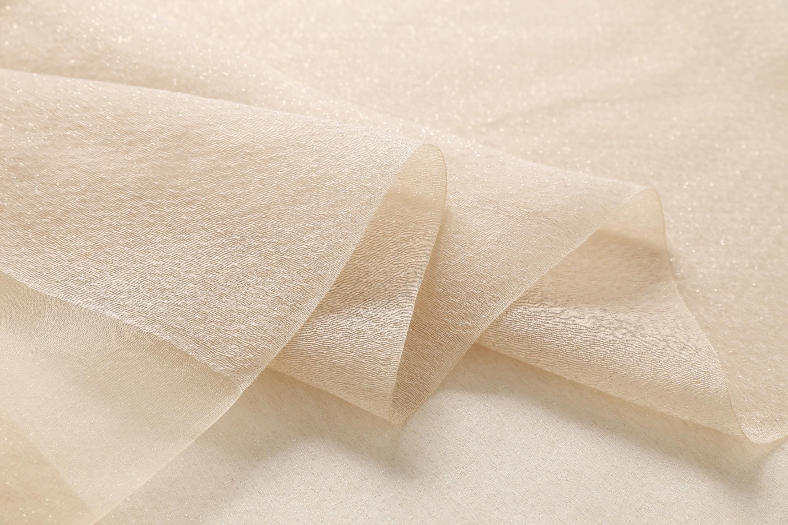Close up of the sheer champagne fabric folds