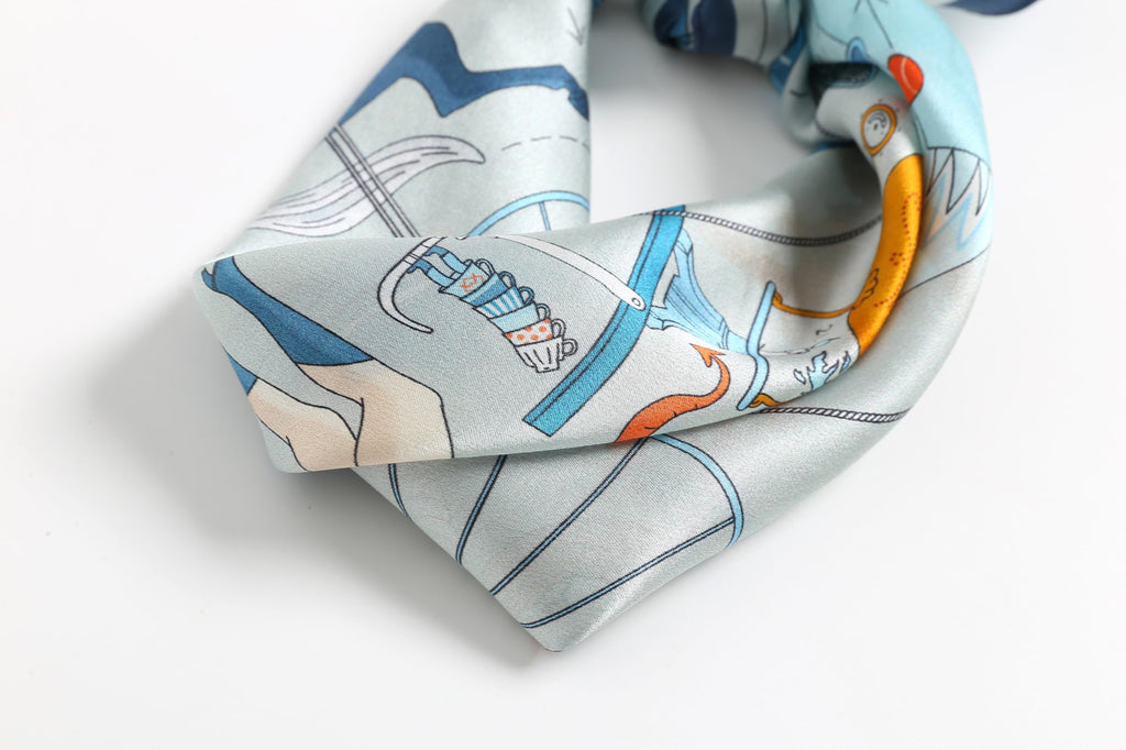Blue illustrated square twisted and tied, orange details on the folded tails