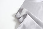 Close-up of the cloud grey square's narrow machine rolled hem along two folded edges