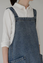 Close view of the denim shoulder strap and the topstitched patch pocket