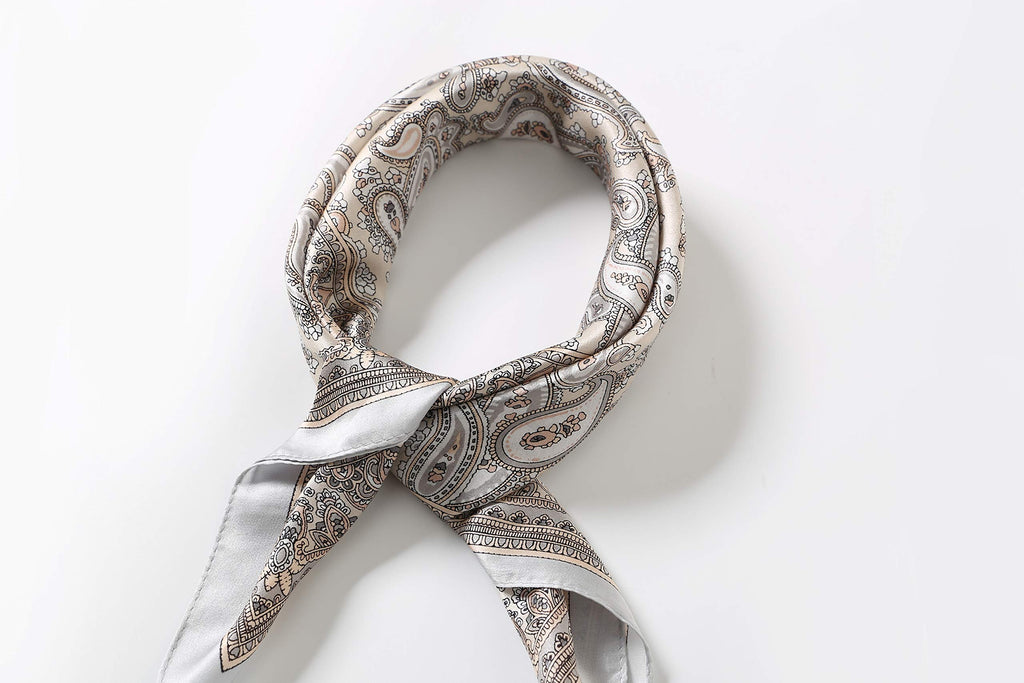 Cream paisley square coiled at the neck with the two grey-edged tails twisted together