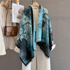 Marbled ink shawl hung open on a rail beside a cream coat and a tan leather bag
