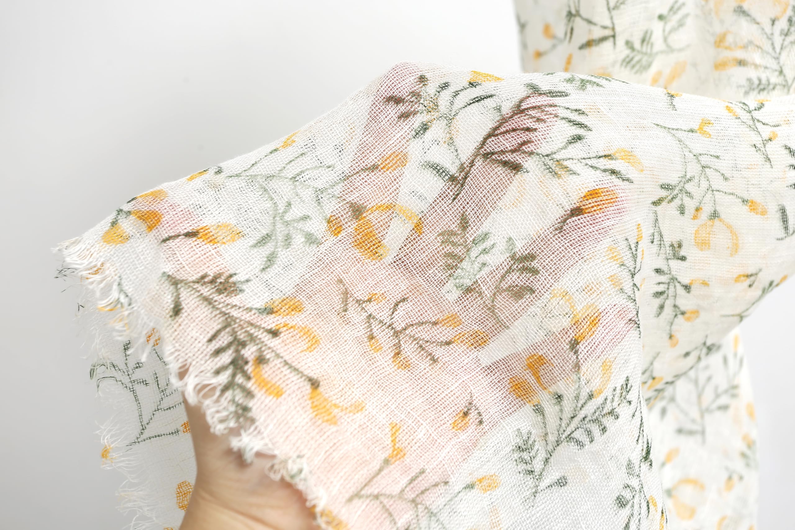 Yellow botanical linen scarf folded showing print repeat and panel width