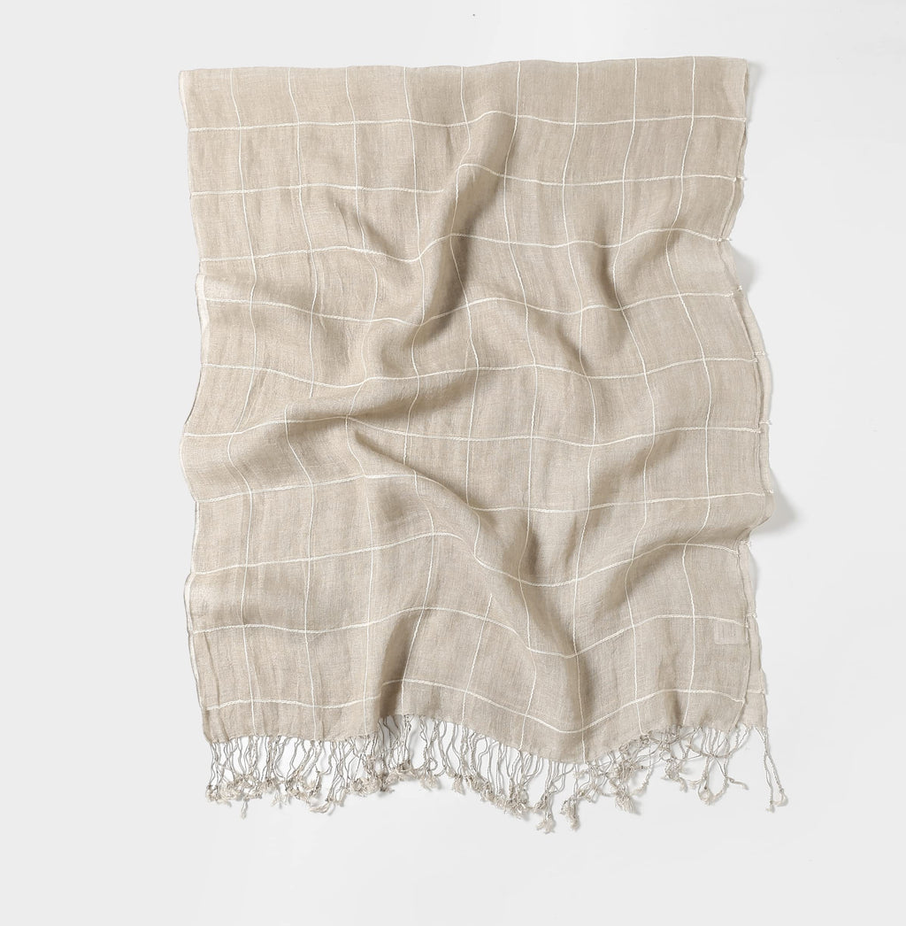 Plaid linen scarf shown draped, the white check grid following the folds of the cloth